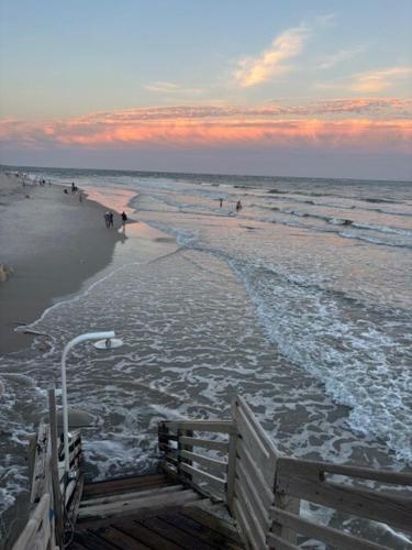 a view of a beach with people walking in the water at Our Waterfront Ocean Pearl in North Topsail Beach