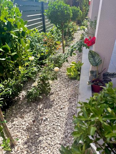 a garden with flowers and plants on the side of a house at Apartments Oriens 7 in Zagreb