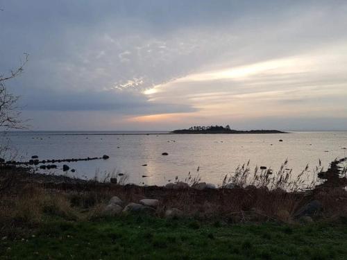 a large body of water with a island in the distance at Charming Harbor Cottage-By Traum in Jægerspris