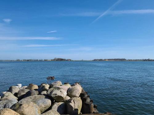 a group of rocks on the edge of a body of water at 6 person holiday home in Juelsminde-By Traum in Sønderby