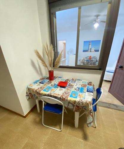 a table with a table cloth on it in a room at Blue Adventure in Torre dell'Orso