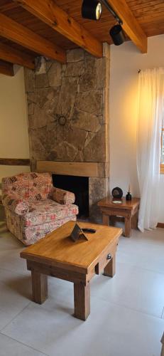a living room with a couch and a coffee table at Apart Hotel Agua Escondida in San Martín de los Andes
