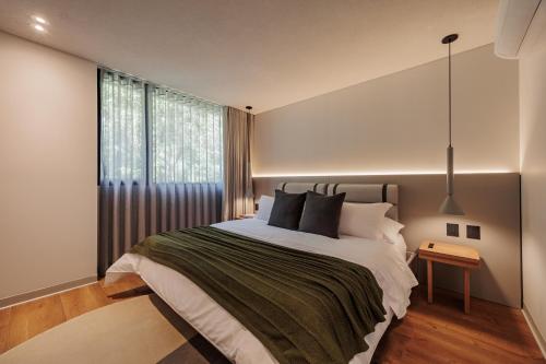 a bedroom with a large bed and a window at Sereno Building in Medellín