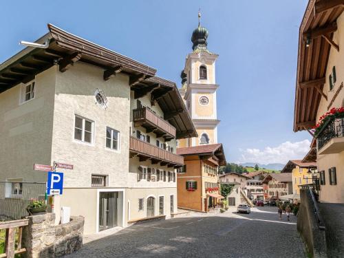 a street in a town with a clock tower at Hopfgarten Alpin Living Top 6 in Hopfgarten im Brixental
