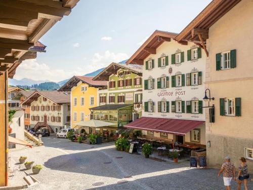 a group of buildings with people walking in a street at Hopfgarten Alpin Living Top 6 in Hopfgarten im Brixental