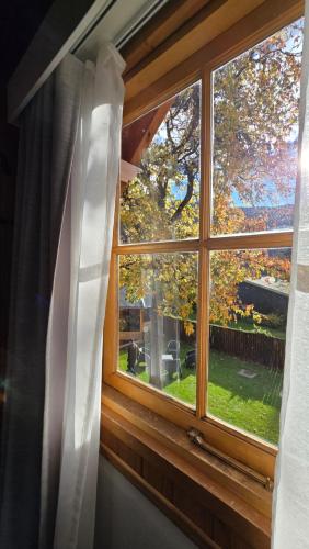 a window with a view of a yard at Apart Hotel Agua Escondida in San Martín de los Andes