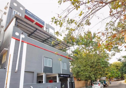 a building with a parking lot in front of it at Super Townhouse RCC Sunrise in Hyderabad