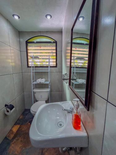 a bathroom with a white sink and a toilet at Casa Mama Fanti in Esquipulas