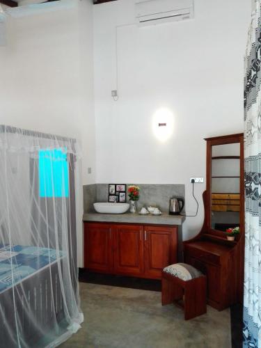 a bedroom with a bed and a sink in a room at Room No2 in Galle
