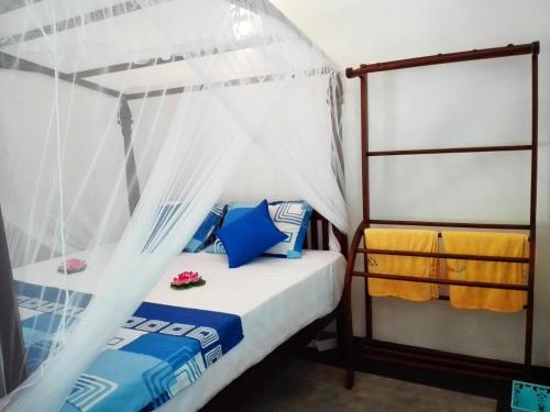 a bedroom with a bed with a canopy at Room No2 in Galle