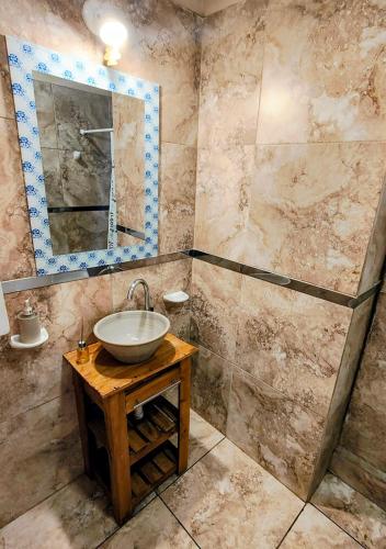 a bathroom with a sink and a mirror at Depto Civora 5 in Villa Regina