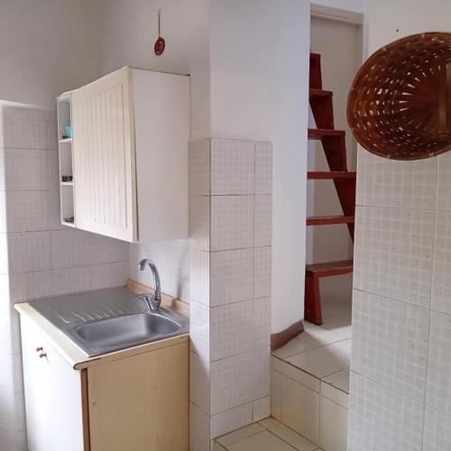 a small kitchen with a sink and a staircase at Casa 28 Luglio-RADICI in Mercatello sul Metauro