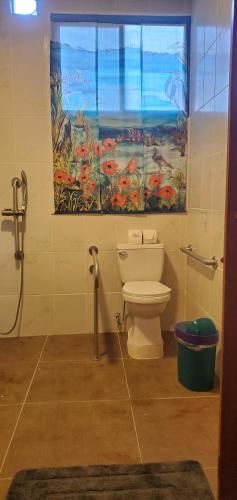 a bathroom with a toilet and a window at Willy's Fish Camp Private Cabin, Drake Bay, Costa Rica in Drake