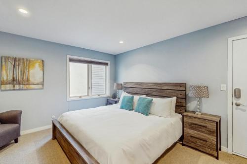 a bedroom with a bed and a chair and a window at Beaver Creek West 22 in Avon