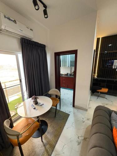 a living room with a table and a couch at Luxurious fully furnished 3 bedroom apartment in Ikate