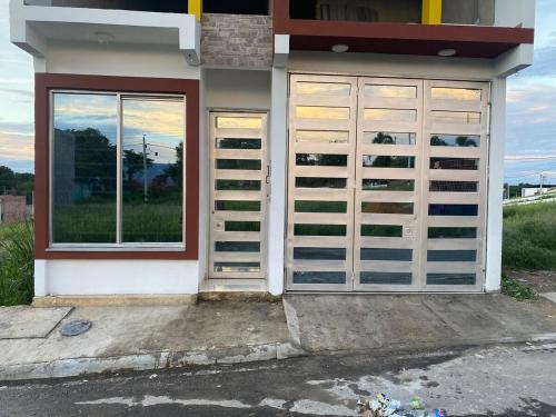a building with doors and a window in front at Tres Palmas apartamento - Carmen de apicalá in Carmen de Apicalá