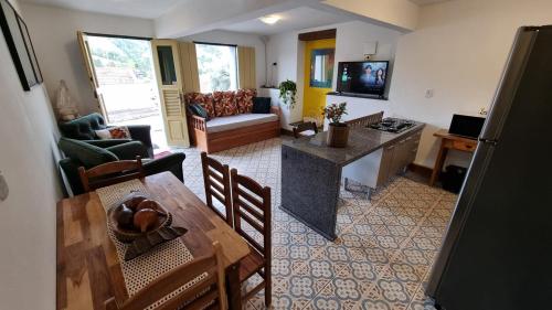 an aerial view of a living room with a table and a kitchen at Casa Dona Luiza 166, Centro, Mountain views in Passa Quatro