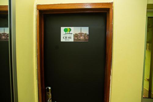 a black door with a sign on it at VILLA DE L'INTEGRATION in Ouagadougou