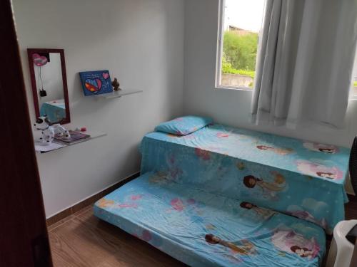 a small room with a bed and a window at George Ferreira in Chã Grande