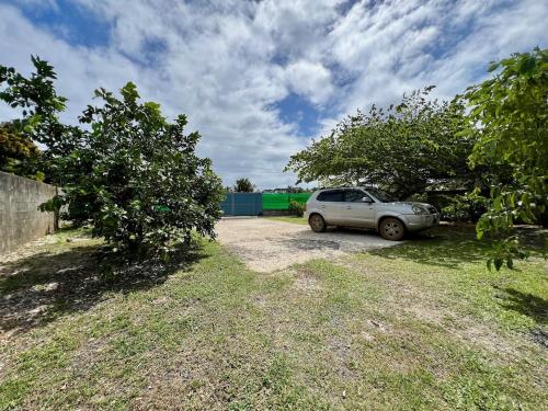 a car parked in a yard next to trees at Nanihi Villa - Little Paradise in HUH