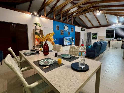 a dining room and living room with a table and chairs at Nanihi Villa - Little Paradise in HUH