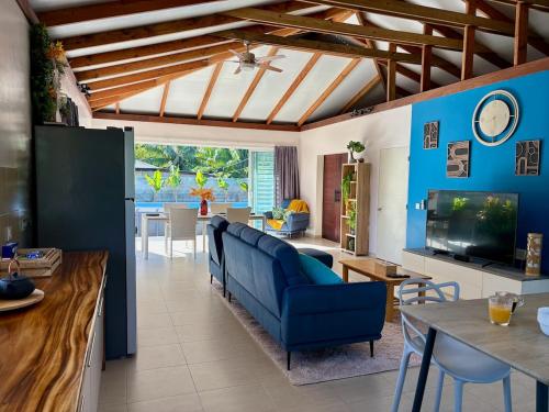 a living room with a blue couch and a television at Nanihi Villa - Little Paradise in HUH