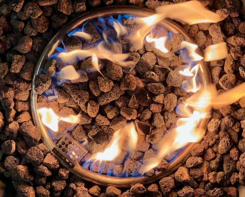 a bowl filled with fire and some rocks at Nanihi Villa - Little Paradise in HUH