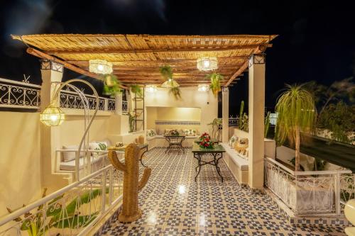 an outdoor patio with a pergola and a table at Dar Bonita in Marrakech