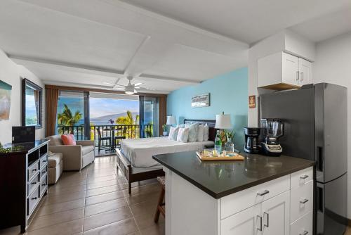 a kitchen and living room with a bed and a refrigerator at Lahaina Shores 523 · LS 523 Direct Beachfront Studio with Stunni in Lahaina