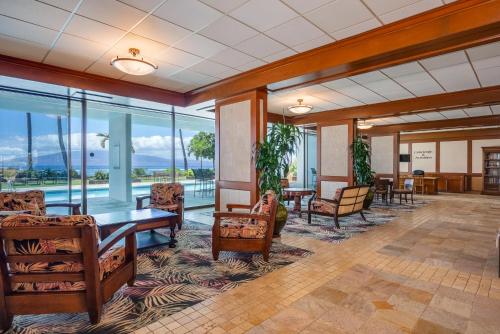 an empty lobby with tables and chairs and windows at Lahaina Shores 523 · LS 523 Direct Beachfront Studio with Stunni in Lahaina