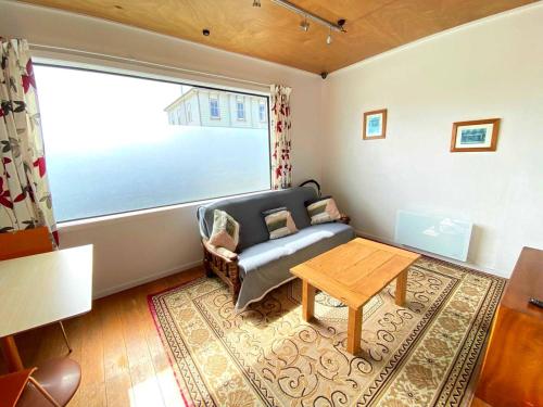 a living room with a couch and a table at Motel style Unit in the Heart of Collingwood in Collingwood