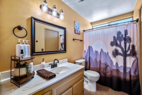 a bathroom with a sink and a toilet and a shower curtain at Jt Desert Dwelling in Twentynine Palms