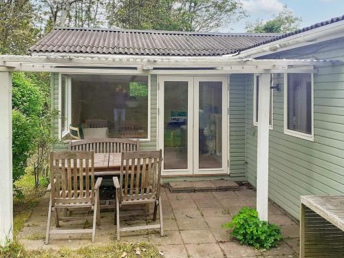 a patio with two chairs and a table on a house at 4 person holiday home in Jægerspris-By Traum in Jægerspris