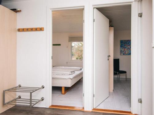 a bedroom with a door leading to a bed at 6 person holiday home in Kolind-By Traum in Kolind