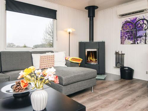 a living room with a couch and a fireplace at 6 person holiday home in Kolind-By Traum in Kolind