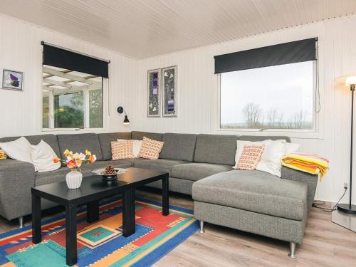 a living room with a couch and a table at 6 person holiday home in Kolind-By Traum in Kolind