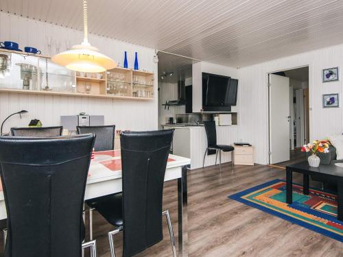 a living room with a table and chairs and a kitchen at 6 person holiday home in Kolind-By Traum in Kolind