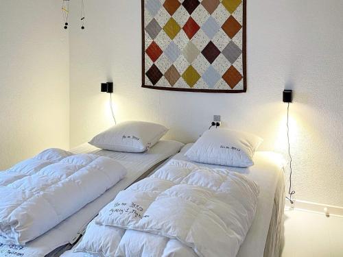 two beds sitting next to each other in a bedroom at 6 person holiday home in Thyborøn-By Traum in Thyborøn