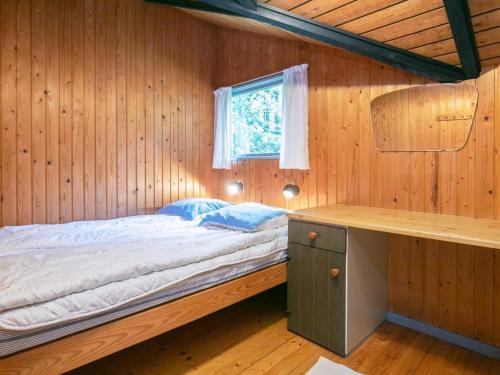 Posto letto in camera in legno con finestra. di Tranquil Cottage Retreat in Lokken-By Traum a Løkken