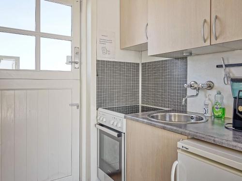 a kitchen with a sink and a counter top at Seaside Escape in Sandkas - By Traum Ferienwohnungen in Allinge