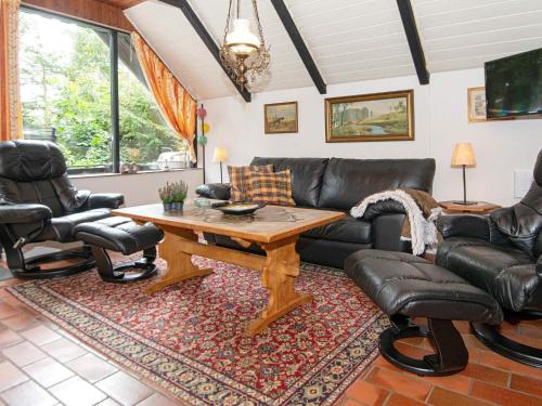 a living room with a leather couch and chairs at 2 person holiday home in Ejstrupholm-By Traum in Krejbjerg