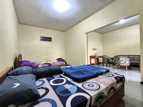 two beds in a room with a person laying on them at Tengger Bromo Villa in Ngadisari