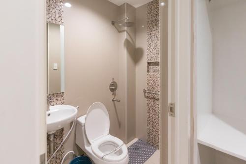 a bathroom with a toilet and a sink at Hotel Sogo Baliwag Bulacan in Baliuag