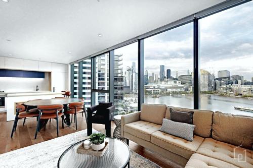 a living room with a couch and a table at Aerie Stays NewQuay Collection in Melbourne