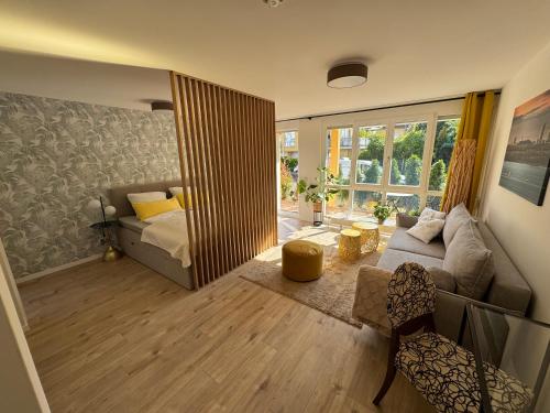 a living room with a couch and a bed in it at Gästeapartment am Agra Park 