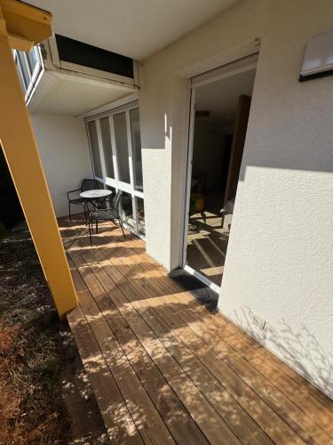 a patio with a table and a patio door at Gästeapartment am Agra Park 