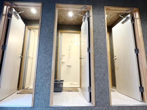 two mirrors on a wall in a bathroom at FujiBaseGotemba Sta 3-mins walk in Gotemba