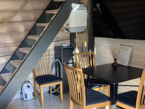 a dining room with a table and chairs and a staircase at 4 person holiday home in TRELLEBORG-By Traum in Trelleborg