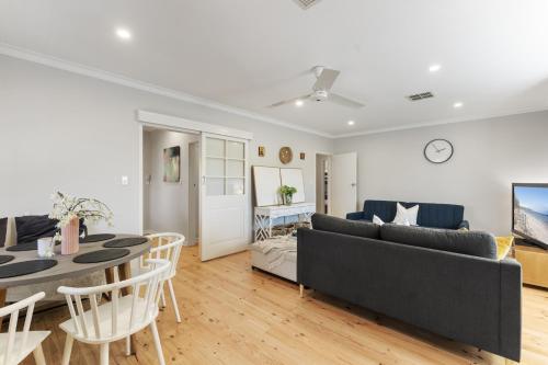 a living room with a couch and a table at Beachside House with Garage and Outdoor Space in Brighton
