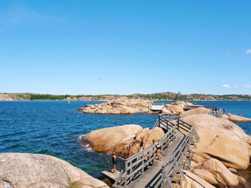 a wooden bridge over a body of water at 6 person holiday home in Bovallstrand-By Traum in Bovallstrand
